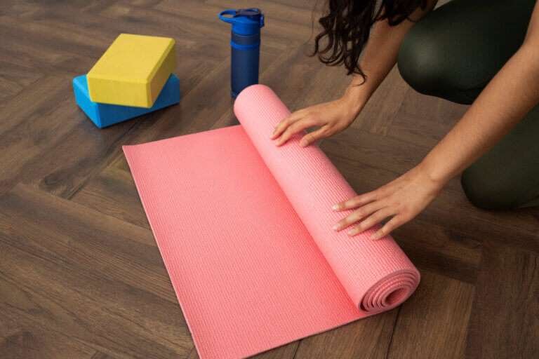 Women Illustrating how to store a yoga mat.
