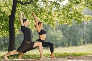 young-sportive-couple-doing-yoga-fitness-people-summer-park_11zon