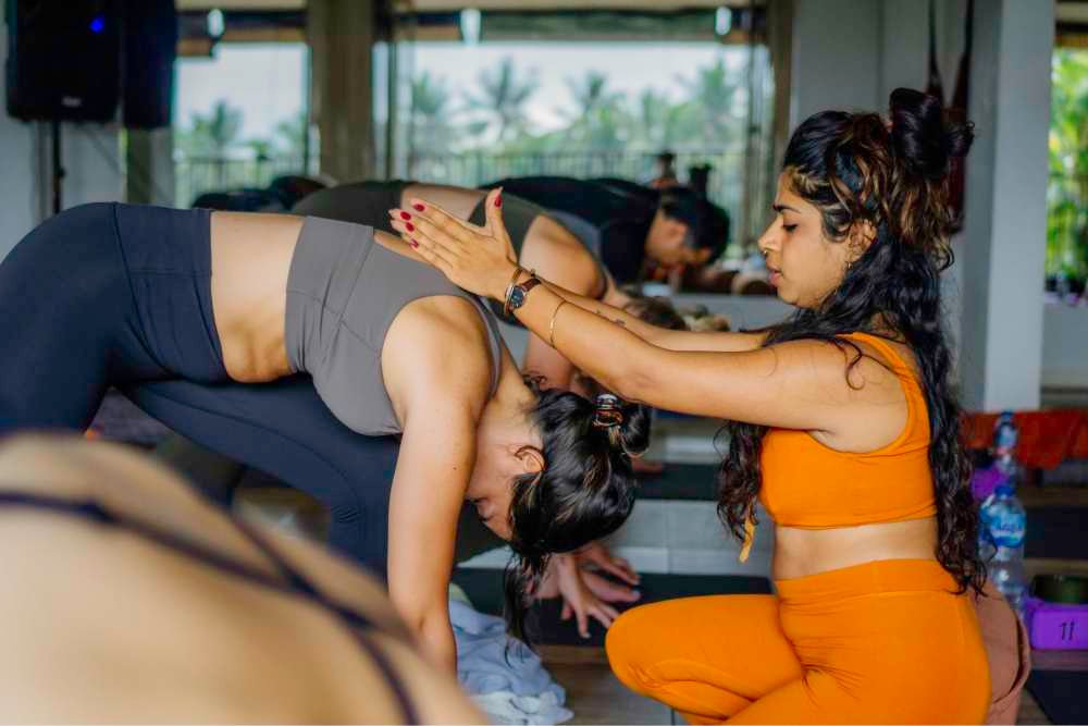 sadhana adjusting a student during class
