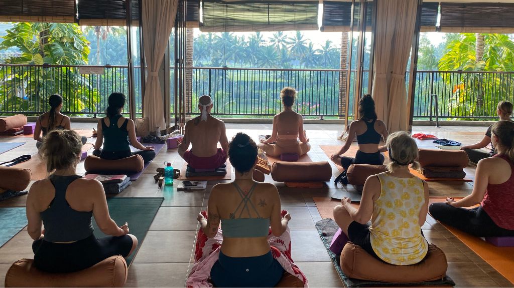 students learning yoga at yoga teacher training program