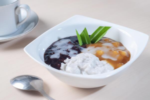Balinese coconut milk pudding dessert, bubur sumsum, with palm sugar syrup.