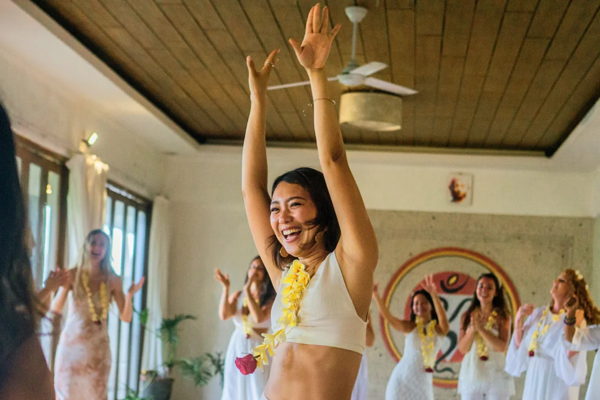 joyful yoga teacher training graduate celebrating completion of 200-hour YTT in Ubud Bali