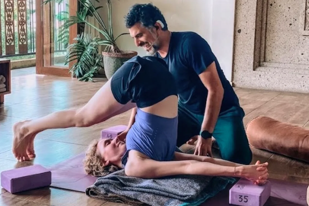 YNV - Instructor Assisting Student in Supine Side Stretch with Blocks
