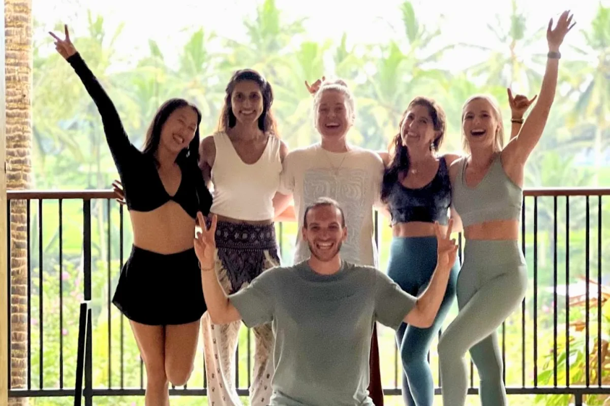 YNV - Joyful Group of Six Students Celebrating on Tropical Balcony