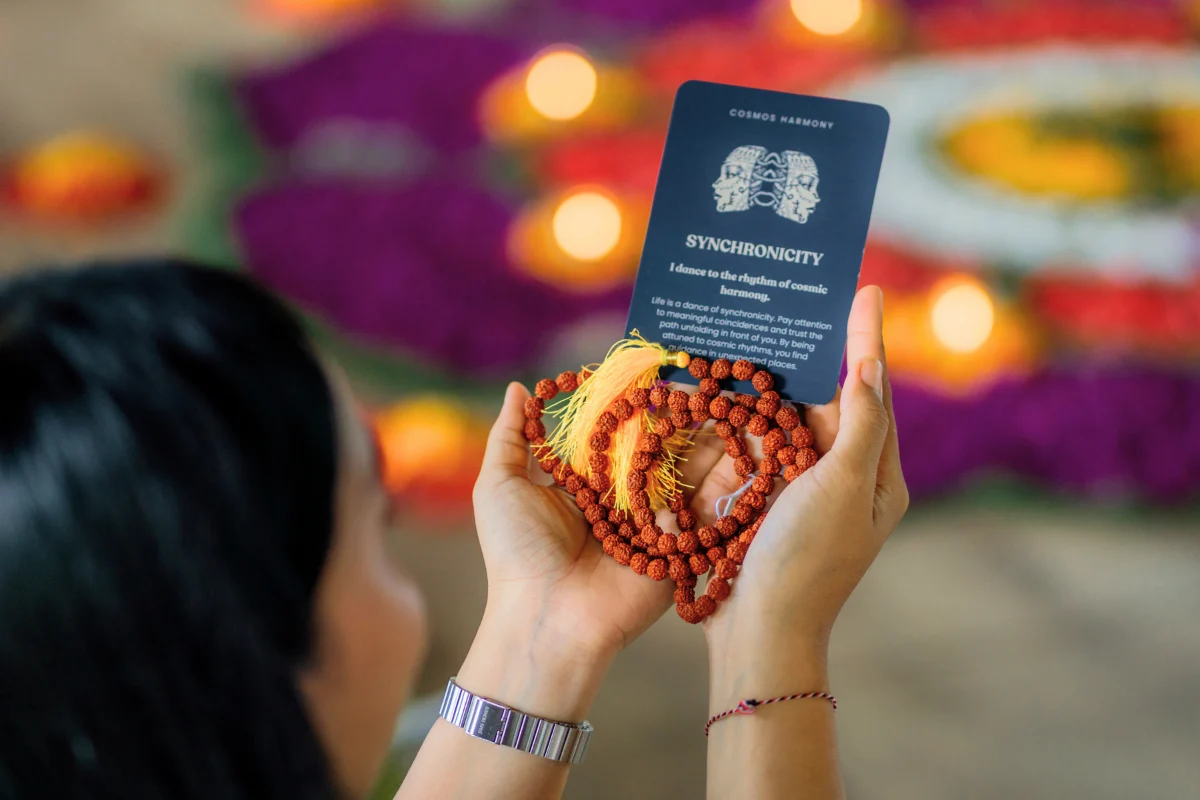 Hands holding mala beads during a meditation session at Yoga New Vision